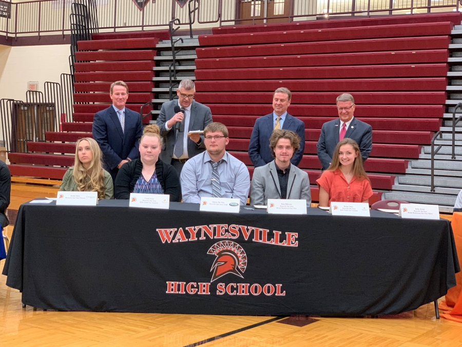 table with several people surrounding it